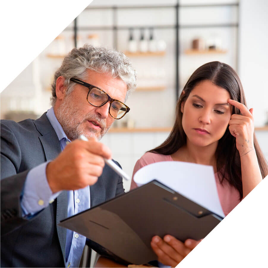 A man and woman are examining a document together, engaged in discussion and analysis of its contents.